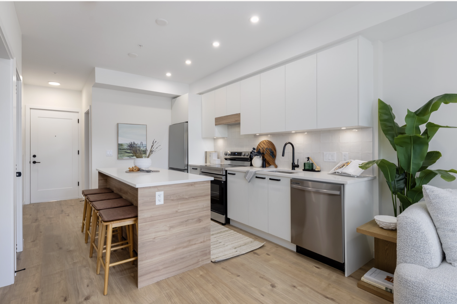 Entryway view into a bright staged kitchen