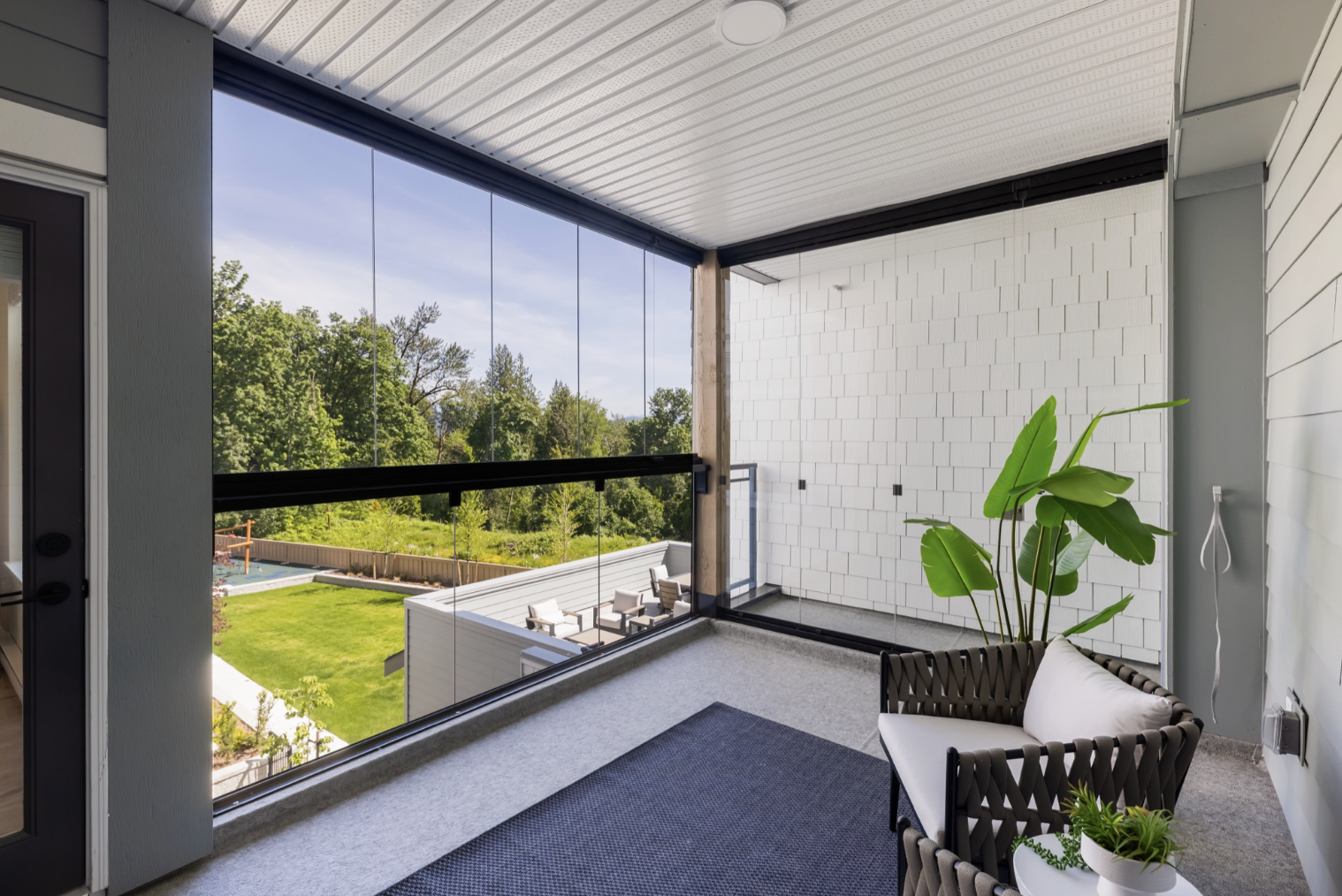 Enclosed balcony with treetop and courtyard views