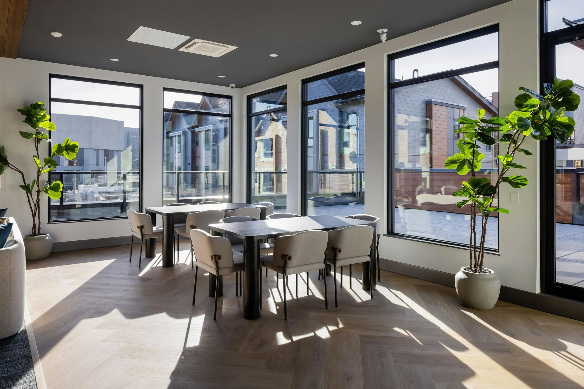 Sunlit amenity lounge overlooking completed townhomes