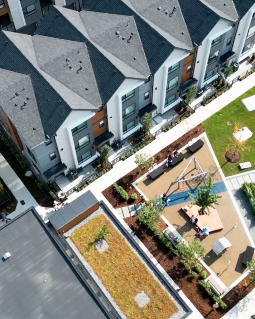 Highstreet Village – aerial view of townhome rooftops and central playground amenity