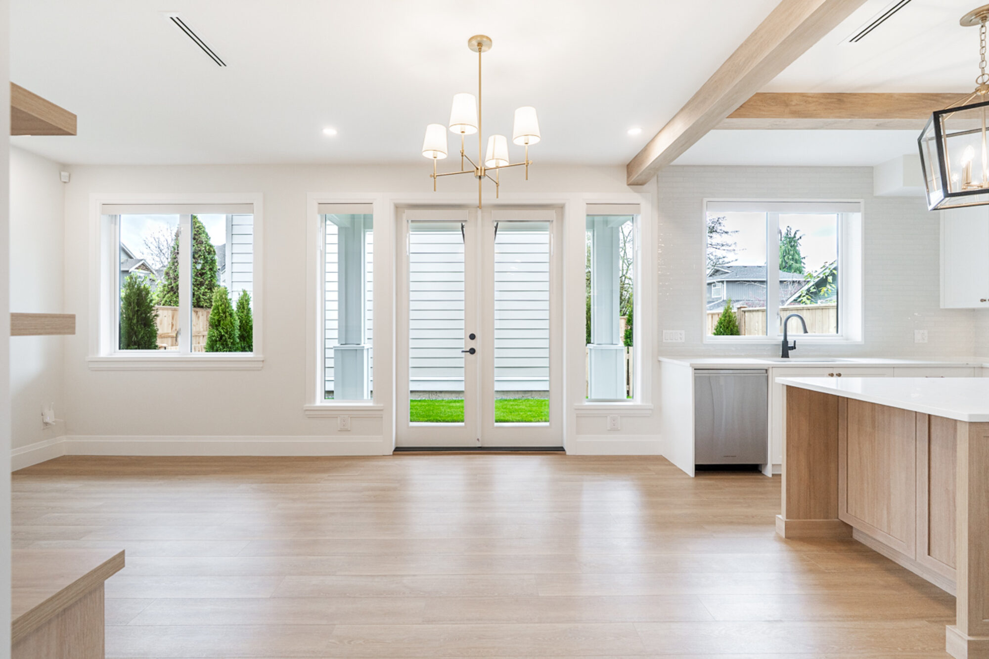 Crescent – Estate great room with chandelier and garden doors